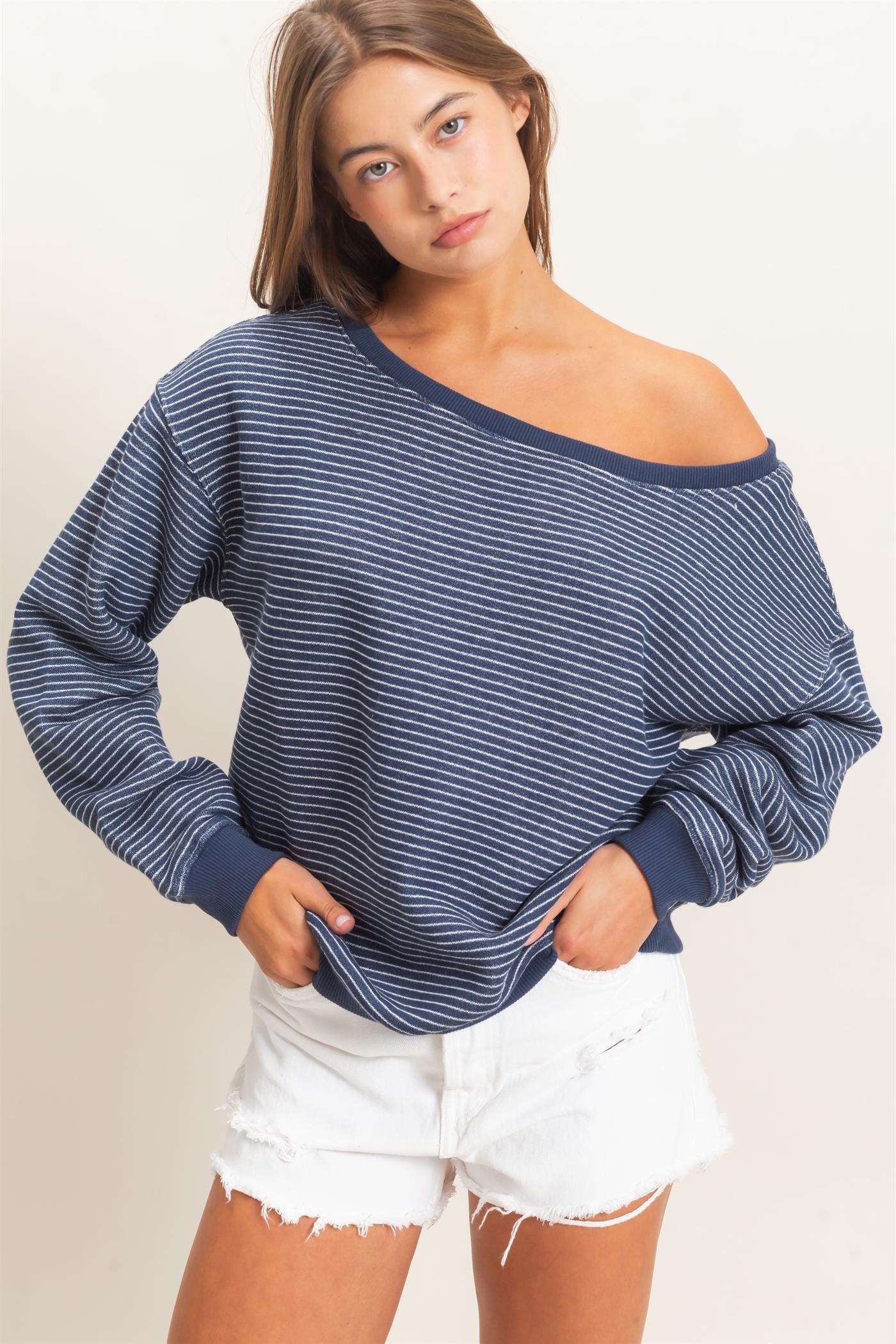 Cozy meets chic in this oversized French terry sweatshirt featuring an off-the-shoulder neckline, relaxed fit, and effortless striped style.