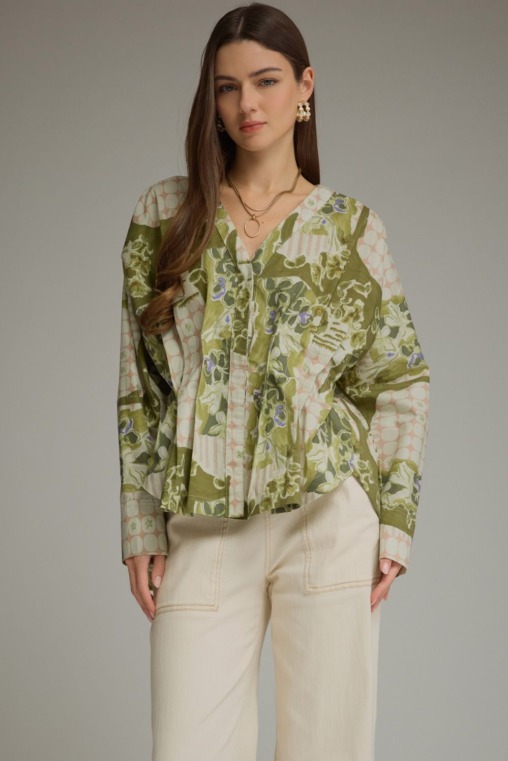 A feminine printed top featuring dramatic balloon sleeves, a flattering V-neck, and a self-tie waist that creates a beautiful peplum silhouette.