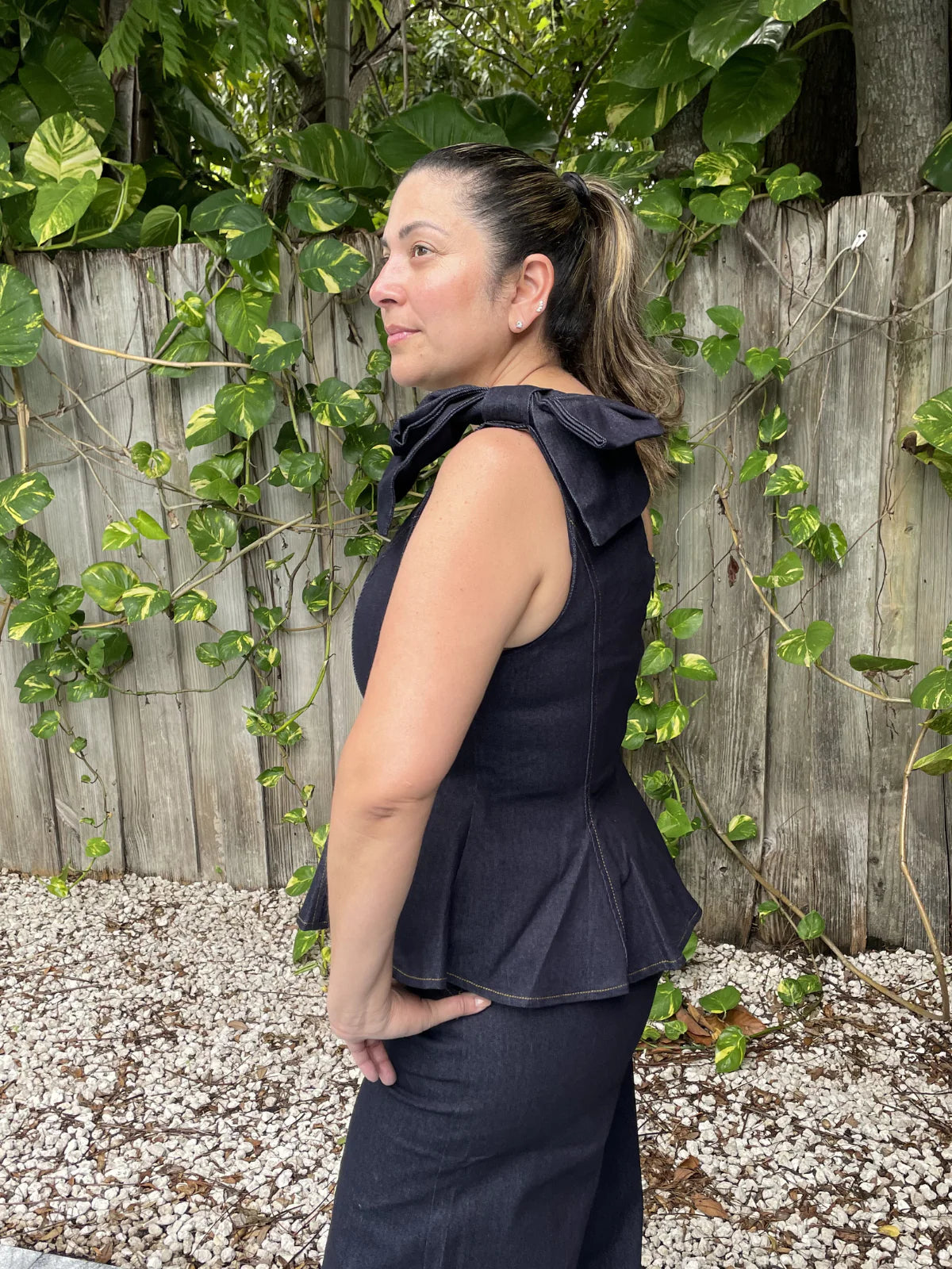 Make a bold statement with this one-shoulder denim peplum top, featuring a feminine bow detail and a flattering silhouette that effortlessly elevates any outfit.
