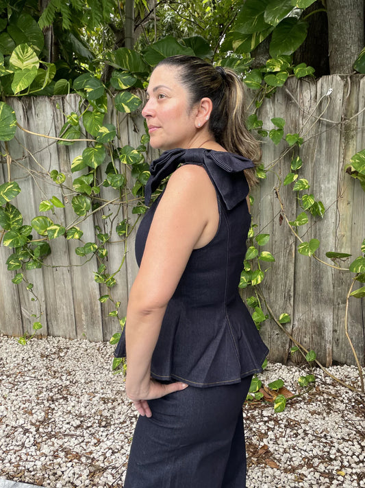 Make a bold statement with this one-shoulder denim peplum top, featuring a feminine bow detail and a flattering silhouette that effortlessly elevates any outfit.
