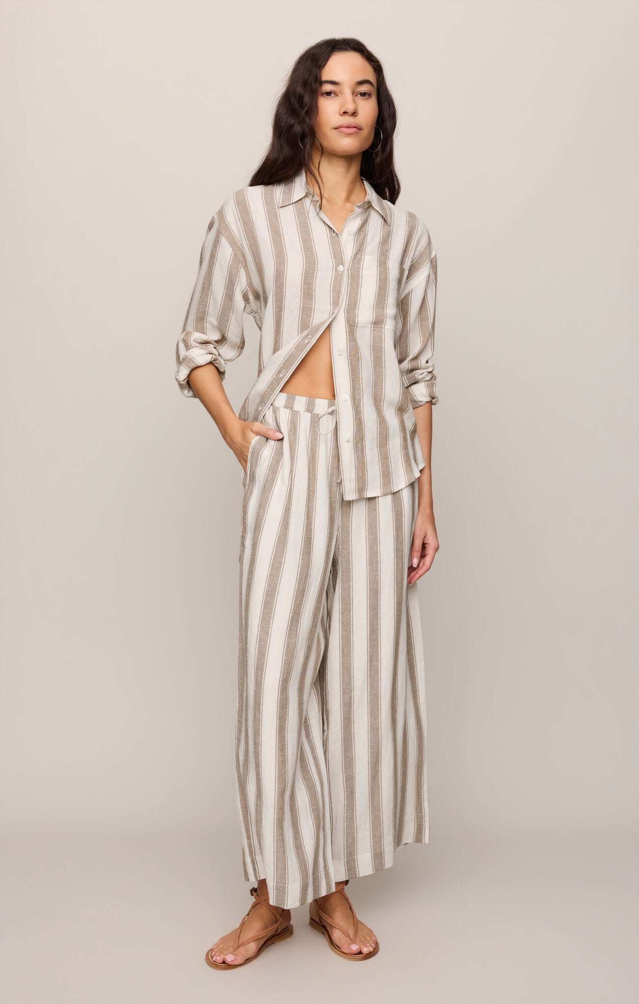 Effortlessly chic and breathable, these striped linen-blend pants feature a high-rise fit, adjustable drawcord waist, and relaxed ankle-length silhouette.