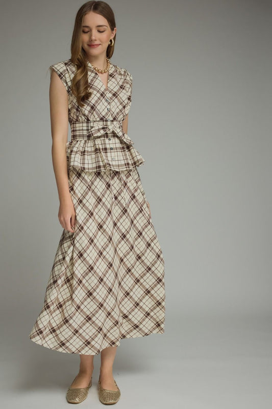 A breezy plaid midi skirt featuring a flattering self-tie waist and feminine ruffle detailing for effortless everyday elegance.

