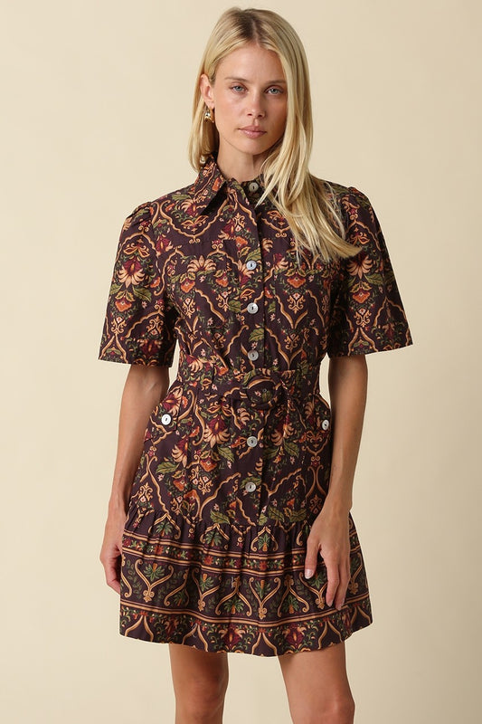 A romantic cotton paisley mini dress featuring a flattering fit-and-flare silhouette, puff sleeves, removable self-tie belt, and tiered ruffle hem.

