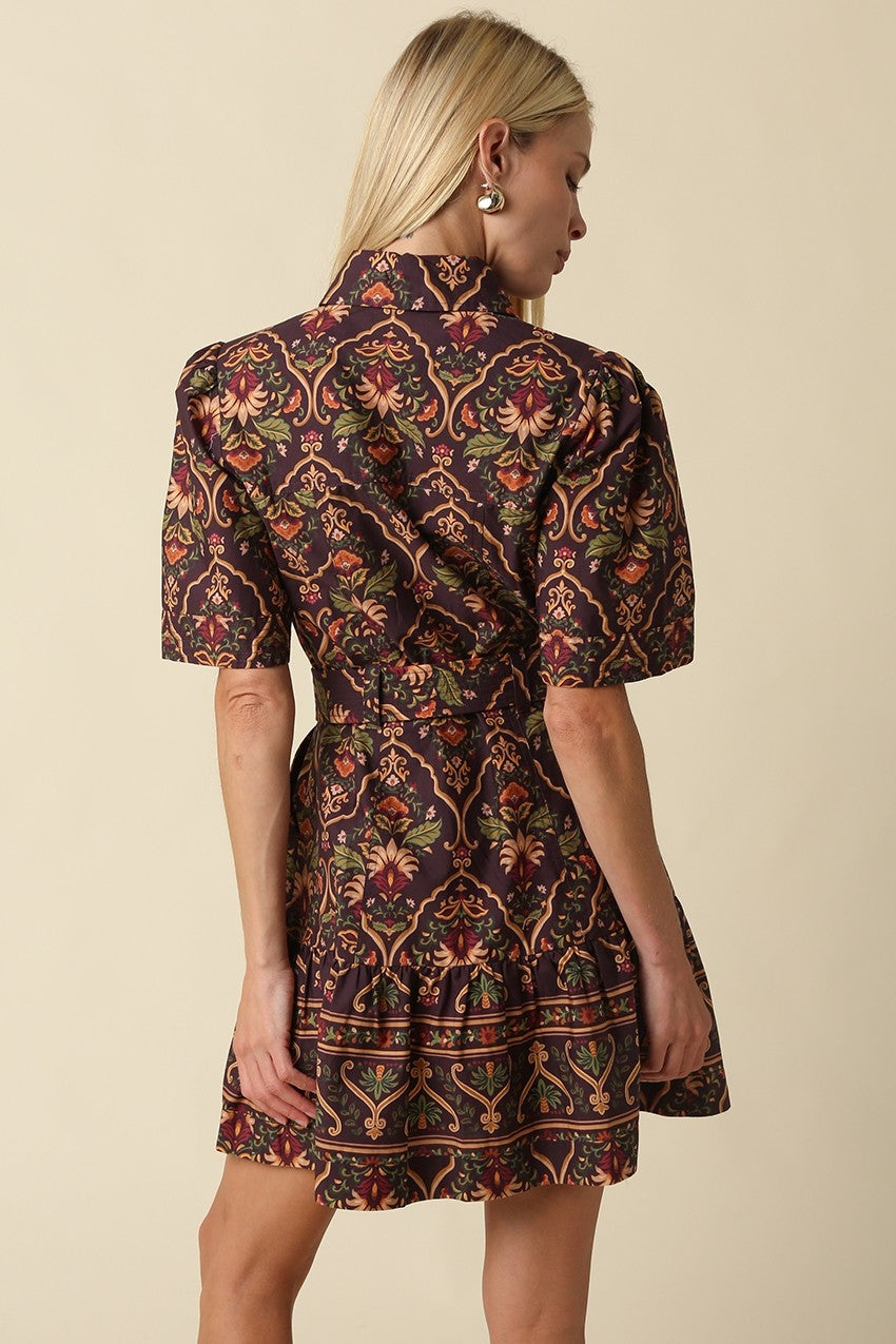 A romantic cotton paisley mini dress featuring a flattering fit-and-flare silhouette, puff sleeves, removable self-tie belt, and tiered ruffle hem.

