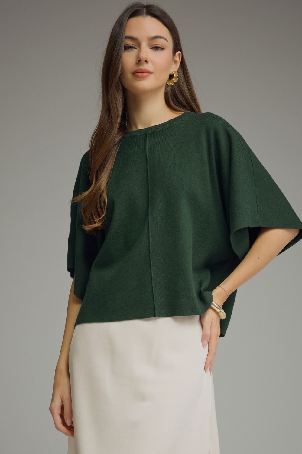 A versatile solid knit top featuring a classic round neckline and lightweight, non-sheer fabric for effortless everyday style.