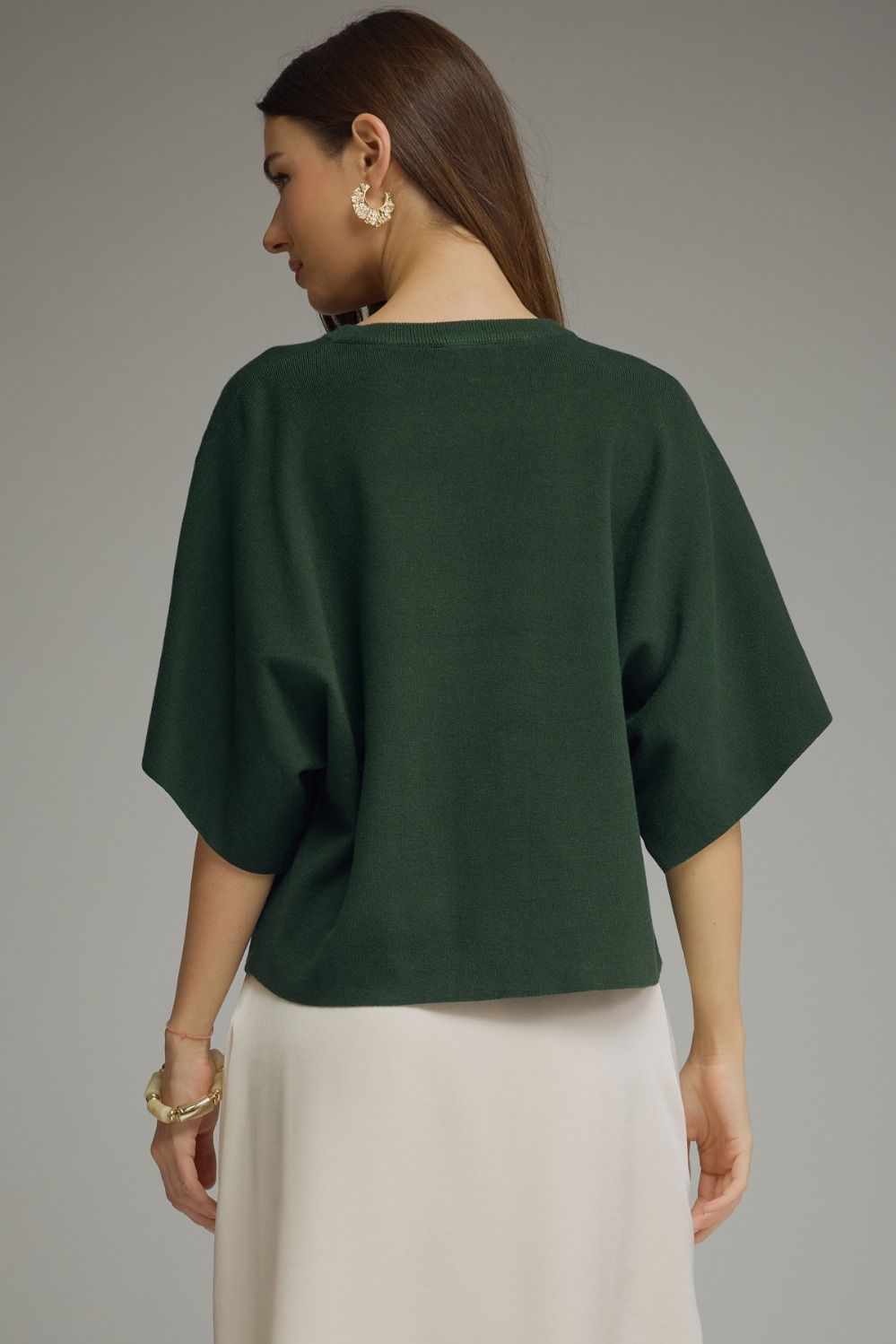 A versatile solid knit top featuring a classic round neckline and lightweight, non-sheer fabric for effortless everyday style.