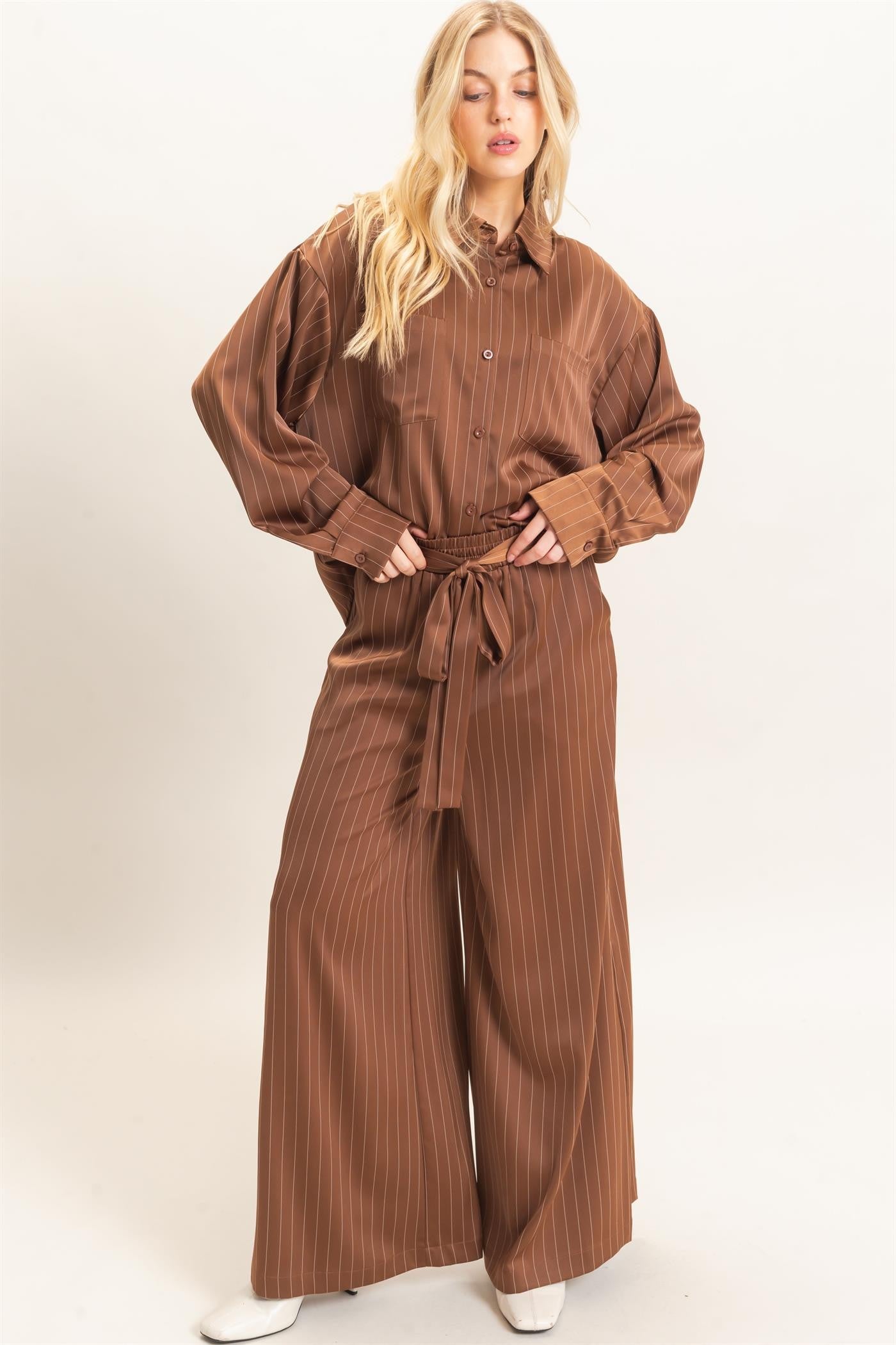 A relaxed striped button-up blouse with a classic spread collar, chest pocket, and button cuffs for effortless polished style.