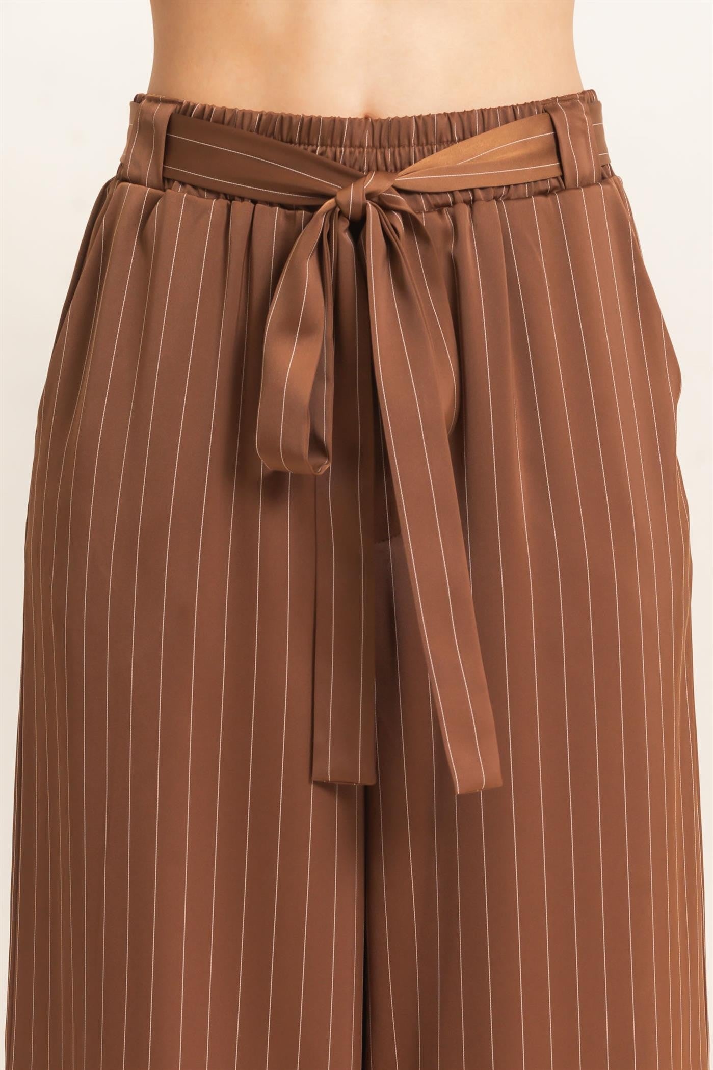 Polished pinstripes meet effortless comfort in these wide-leg pants featuring a flexible elastic waistband and flattering self-tie waist belt.