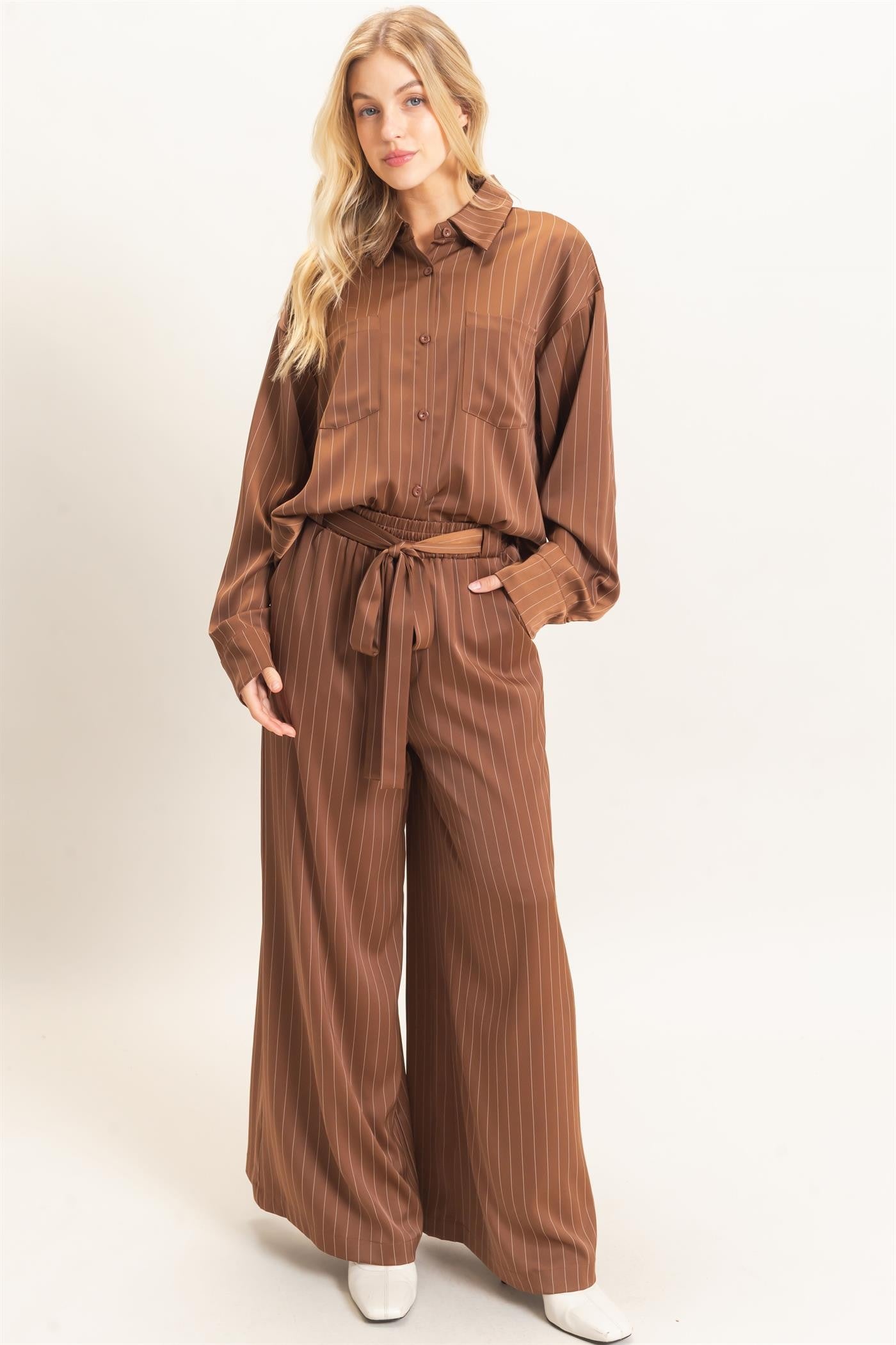 Polished pinstripes meet effortless comfort in these wide-leg pants featuring a flexible elastic waistband and flattering self-tie waist belt.