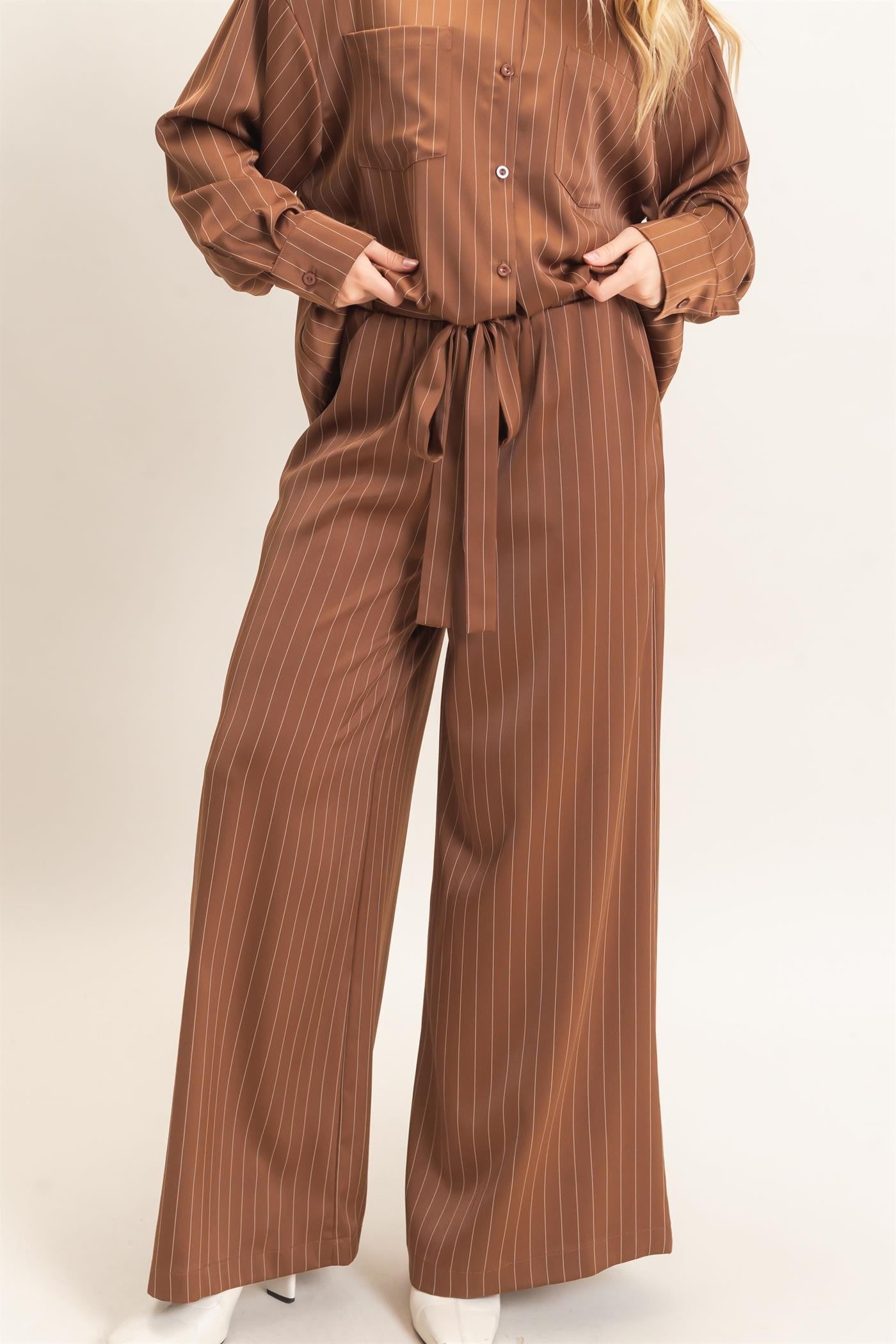 Polished pinstripes meet effortless comfort in these wide-leg pants featuring a flexible elastic waistband and flattering self-tie waist belt.