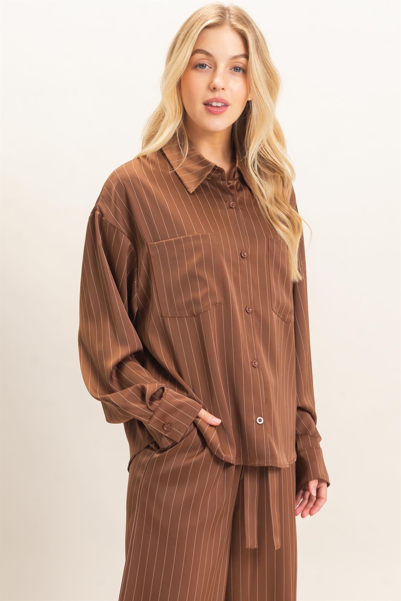 A relaxed striped button-up blouse with a classic spread collar, chest pocket, and button cuffs for effortless polished style.
