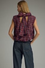 The Eleanor Plaid Top pairs a classic plaid pattern with feminine texture, a high neckline, and a playful bubble hem for a fresh, elevated look.