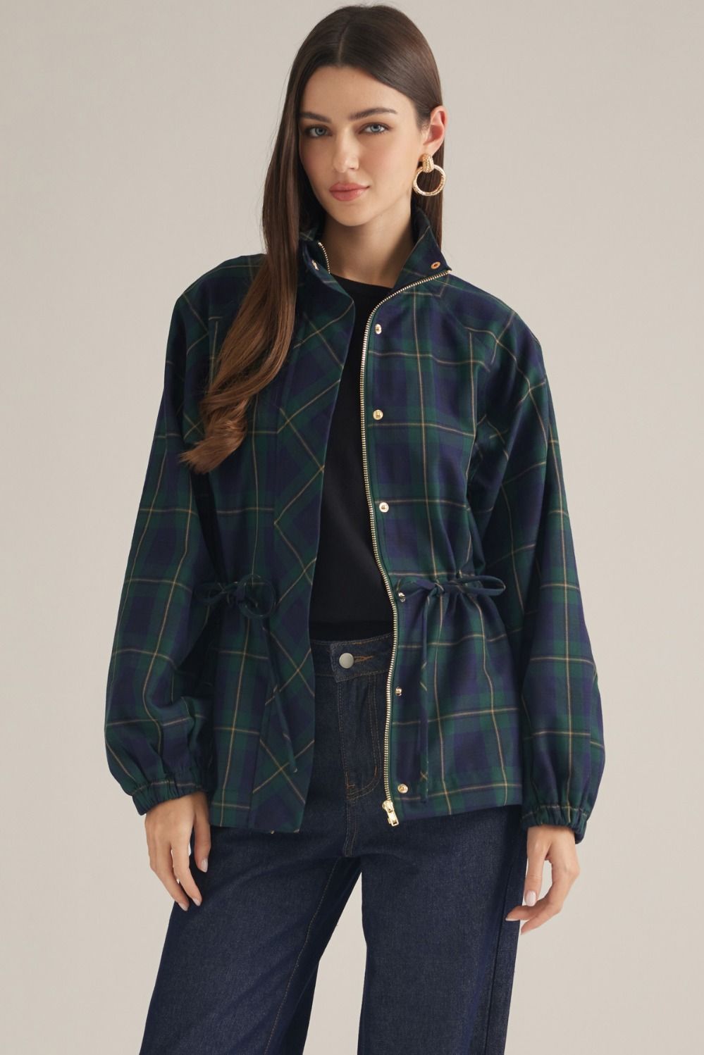A lightweight plaid jacket featuring a high neckline, adjustable drawstring waist, and zip-front design for effortless seasonal layering.
