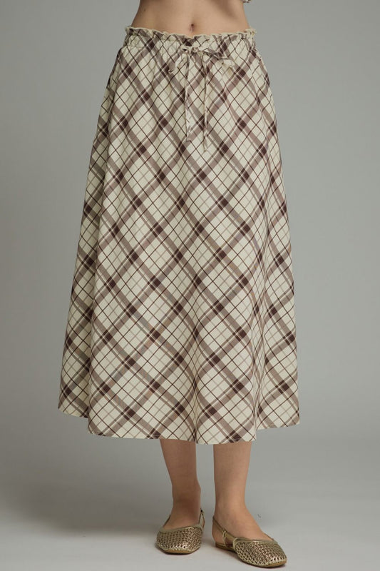 A breezy plaid midi skirt featuring a flattering self-tie waist and feminine ruffle detailing for effortless everyday elegance.

