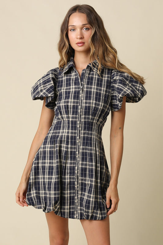 A fashion-forward plaid mini dress featuring a collared zip-front neckline, puff sleeves, and a voluminous bubble hem for standout seasonal style.