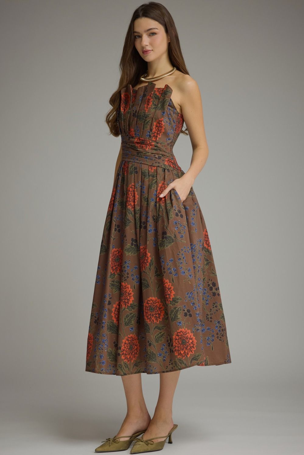 A feminine floral midi dress featuring a unique neckline created by the beautifully pleated bodice, comfortable smocked back, and convenient side pockets.