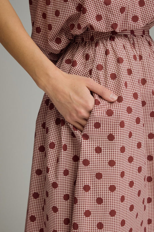 A charming gingham polka dot midi skirt featuring a gathered waist, functional pockets, and a lightweight lined design for effortless feminine style.