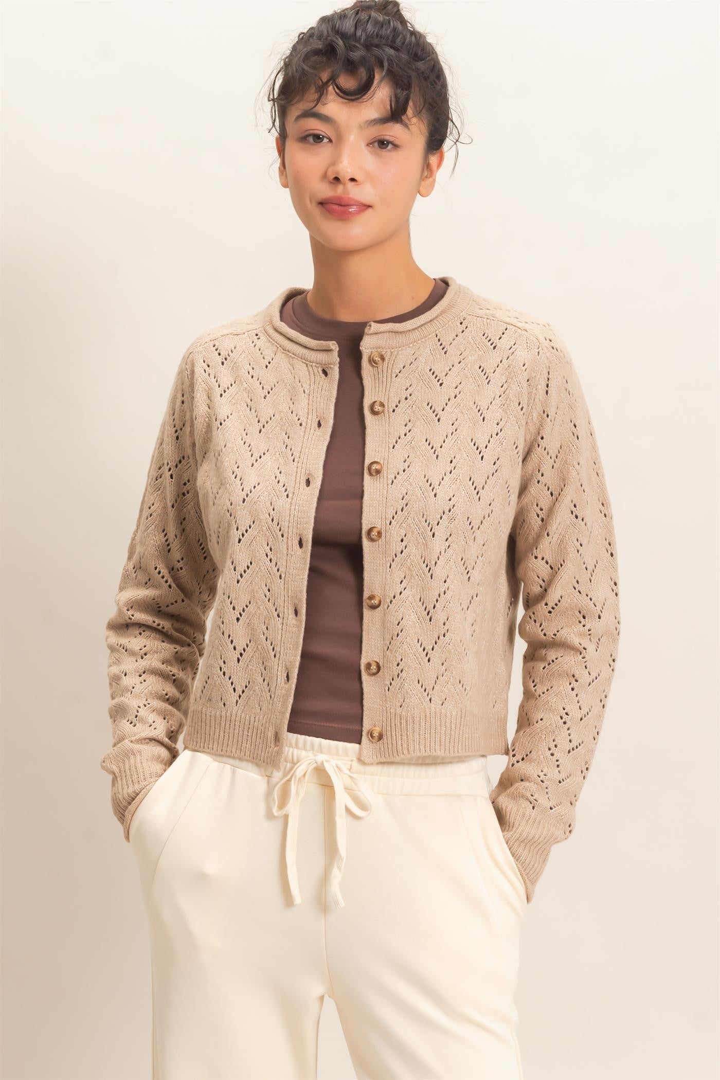 A timeless layering essential, this pointelle knit cardigan features a slightly cropped silhouette, button-front styling, and delicate details for effortless everyday charm.
