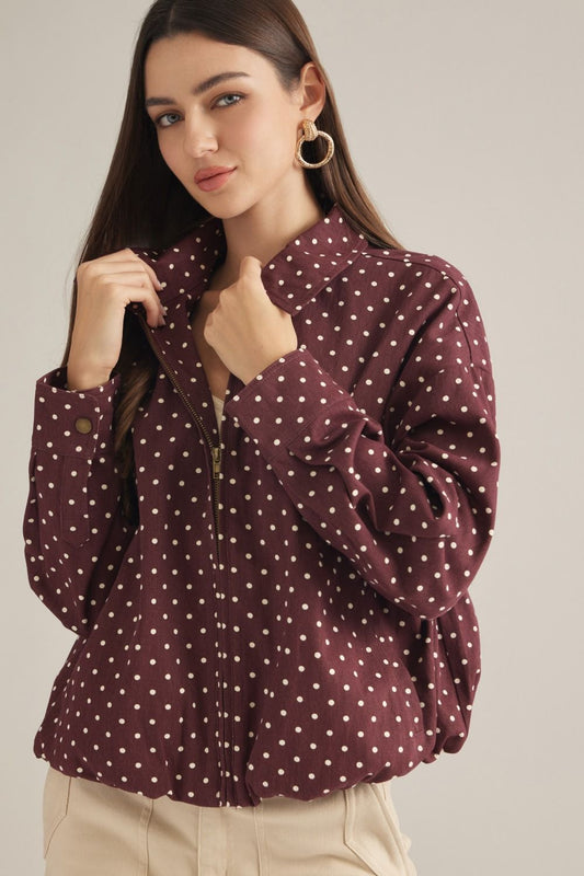 A lightweight polka dot jacket featuring a collared neckline, zip-front closure, and elastic hem for effortless everyday layering.
