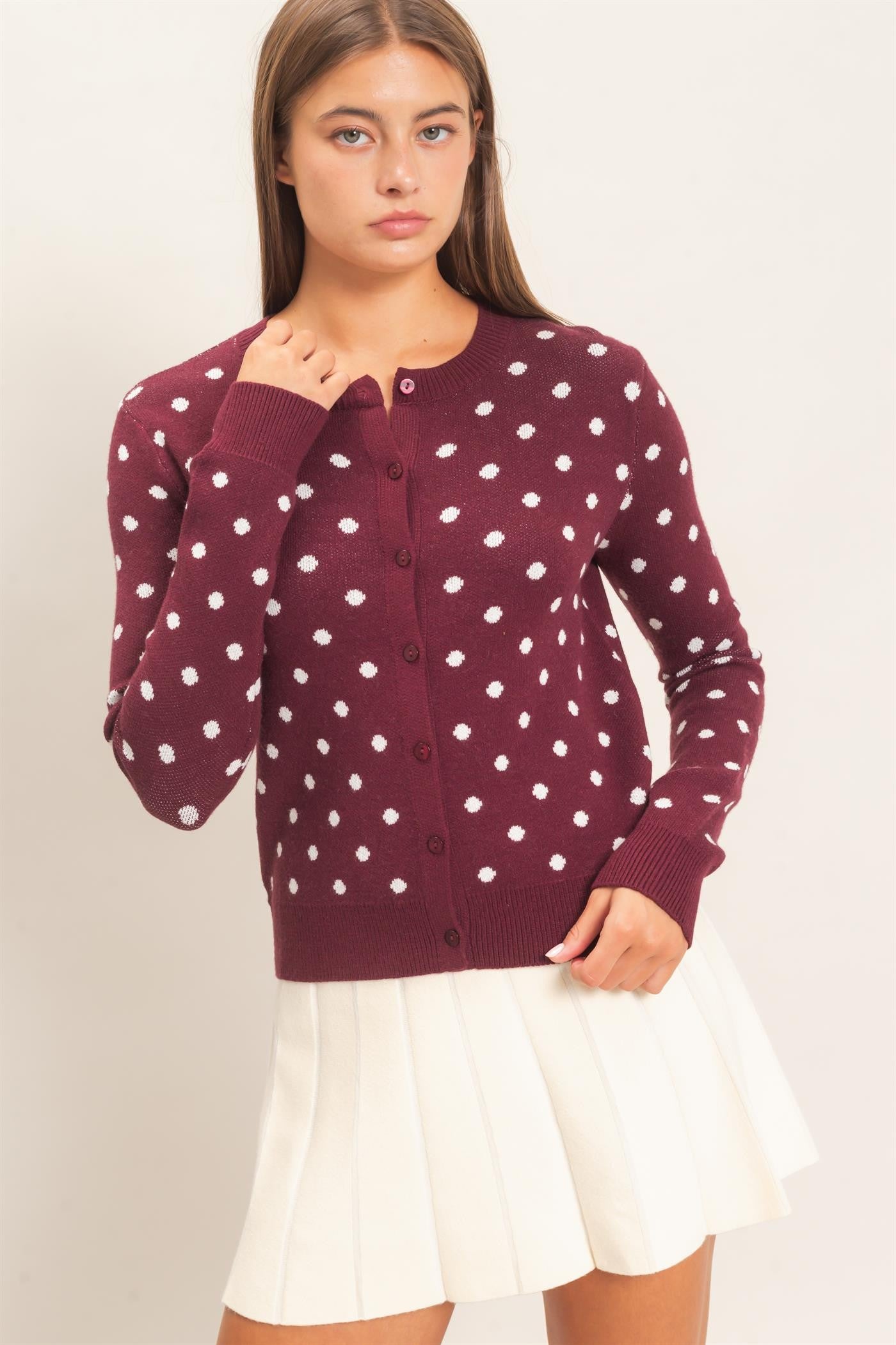 A timeless polka dot cardigan with a classic crew neckline and button-front design that adds effortless charm to everyday and office-ready looks.

