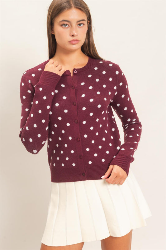 A timeless polka dot cardigan with a classic crew neckline and button-front design that adds effortless charm to everyday and office-ready looks.
