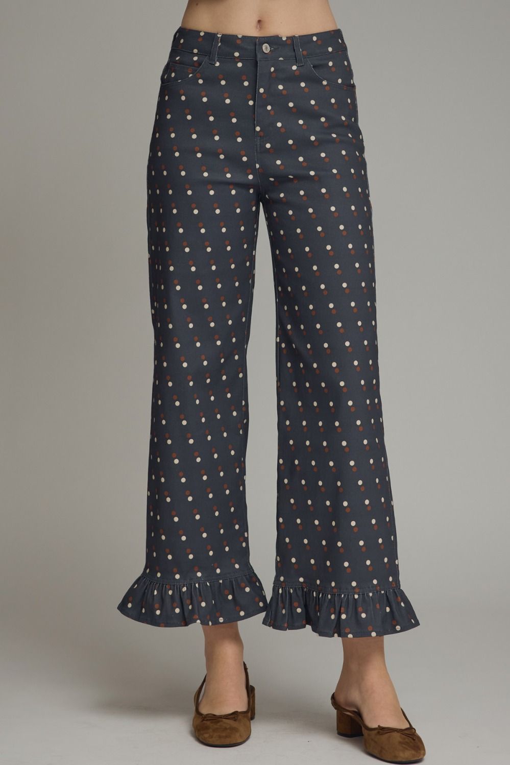 Make every outfit memorable with these playful polka dot denim pants featuring a flattering straight-leg silhouette and feminine ruffle hems.