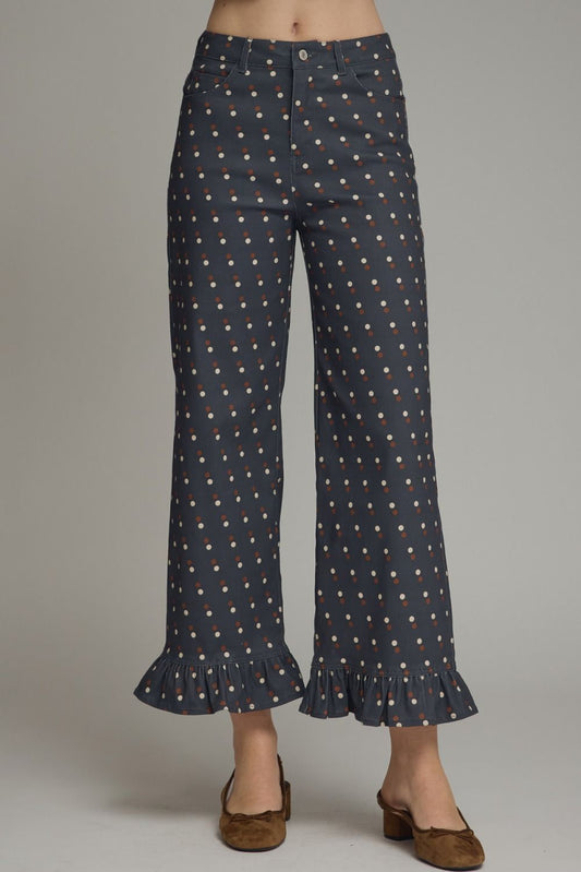Make every outfit memorable with these playful polka dot denim pants featuring a flattering straight-leg silhouette and feminine ruffle hems.