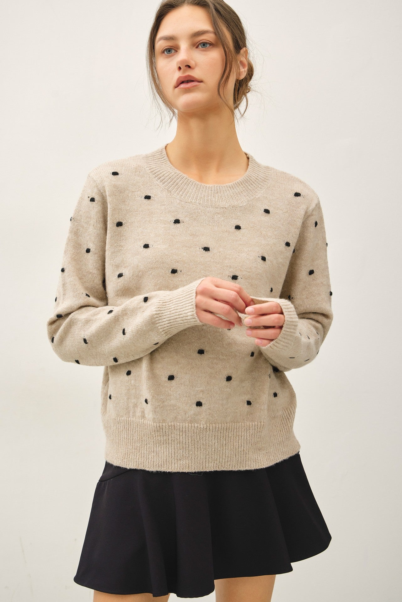 Model wearing the Colette Dotted Knit Sweater featuring a classic crew neckline, subtle dotted knit texture, long sleeves, lightweight ultra-soft fabric, and relaxed fit 