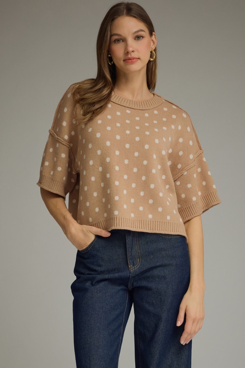 A charming polka dot knit top featuring a classic round neckline, short sleeves, and ribbed trim for a polished everyday look.

