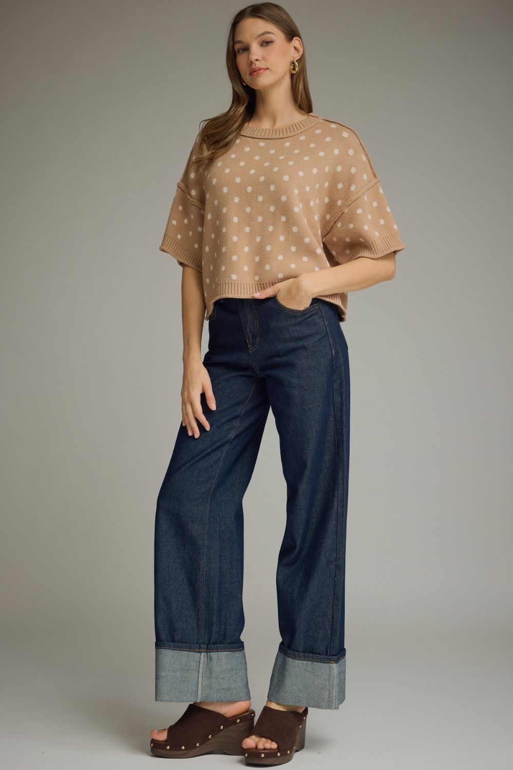 A charming polka dot knit top featuring a classic round neckline, short sleeves, and ribbed trim for a polished everyday look.

