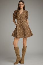 A playful cotton polka dot mini dress featuring feminine puff sleeves, a flattering V-neckline, and convenient side pockets.

