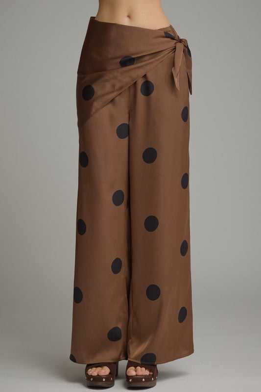 Feminine polka dot wide leg pants featuring a stylish self-tie wrap waist, comfortable elastic back, and convenient side pockets.

