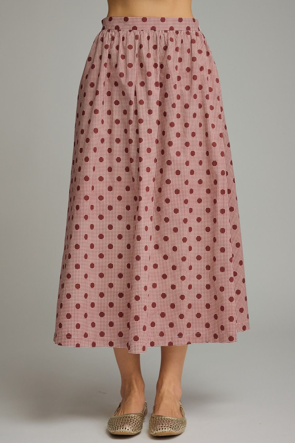 A charming gingham polka dot midi skirt featuring a gathered waist, functional pockets, and a lightweight lined design for effortless feminine style.