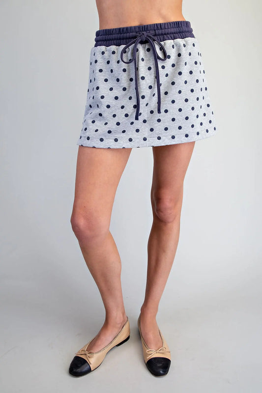 A playful mineral washed skort featuring a classic polka dot print, built-in shorts, and a comfortable drawstring waistband for effortless everyday style.
