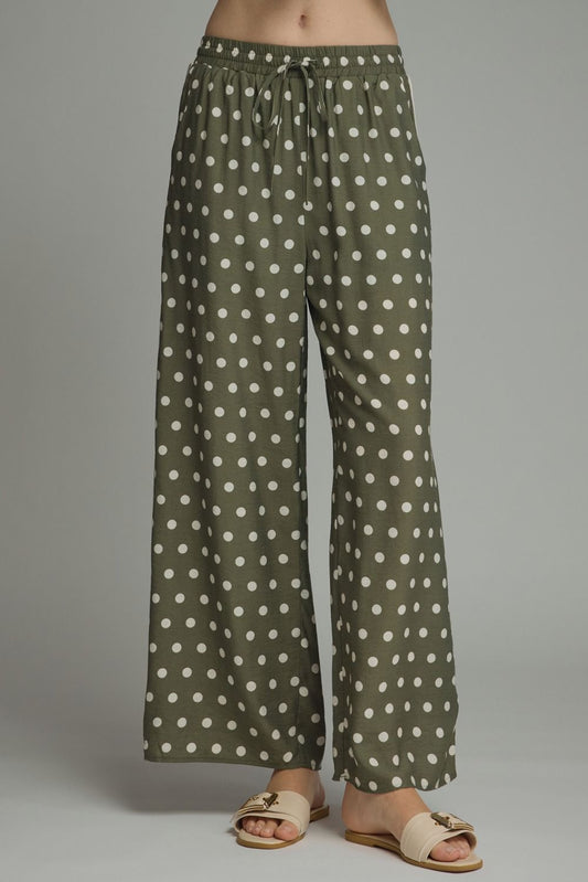 Playful polka dot pants with a relaxed wide leg silhouette, contrast trim, and an adjustable drawstring waist for effortless everyday style.