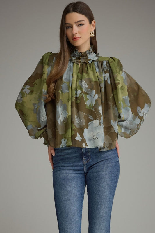 A romantic printed blouse featuring voluminous long sleeves, a ruffled stand collar, feminine button details, and delicate ruffle-trimmed cuffs.

