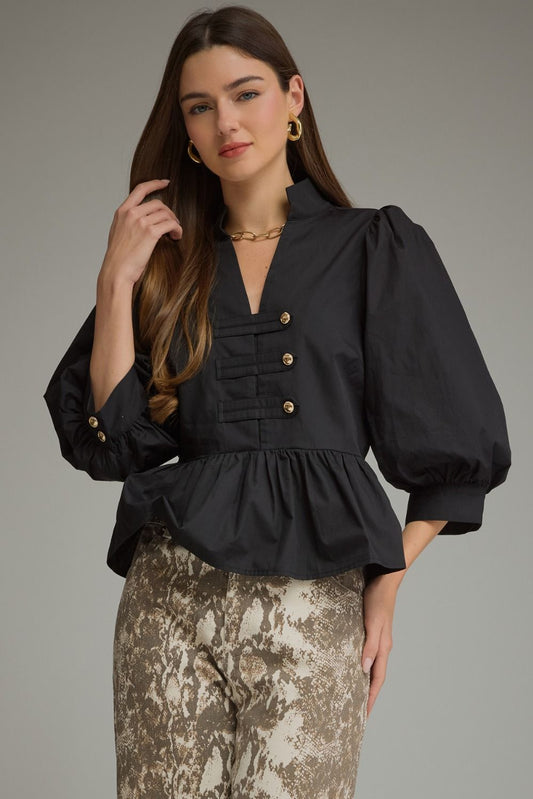 A feminine ¾-sleeve peplum top featuring romantic puff sleeves, a flattering split neckline, and stylish button-tab detailing.

