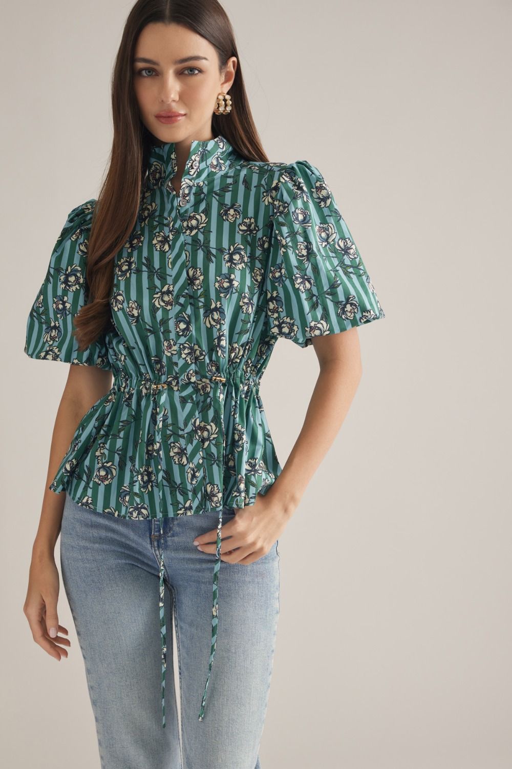 A charming stripe floral blouse featuring puff sleeves, a split neckline, and a flattering drawstring waist for effortless feminine style.