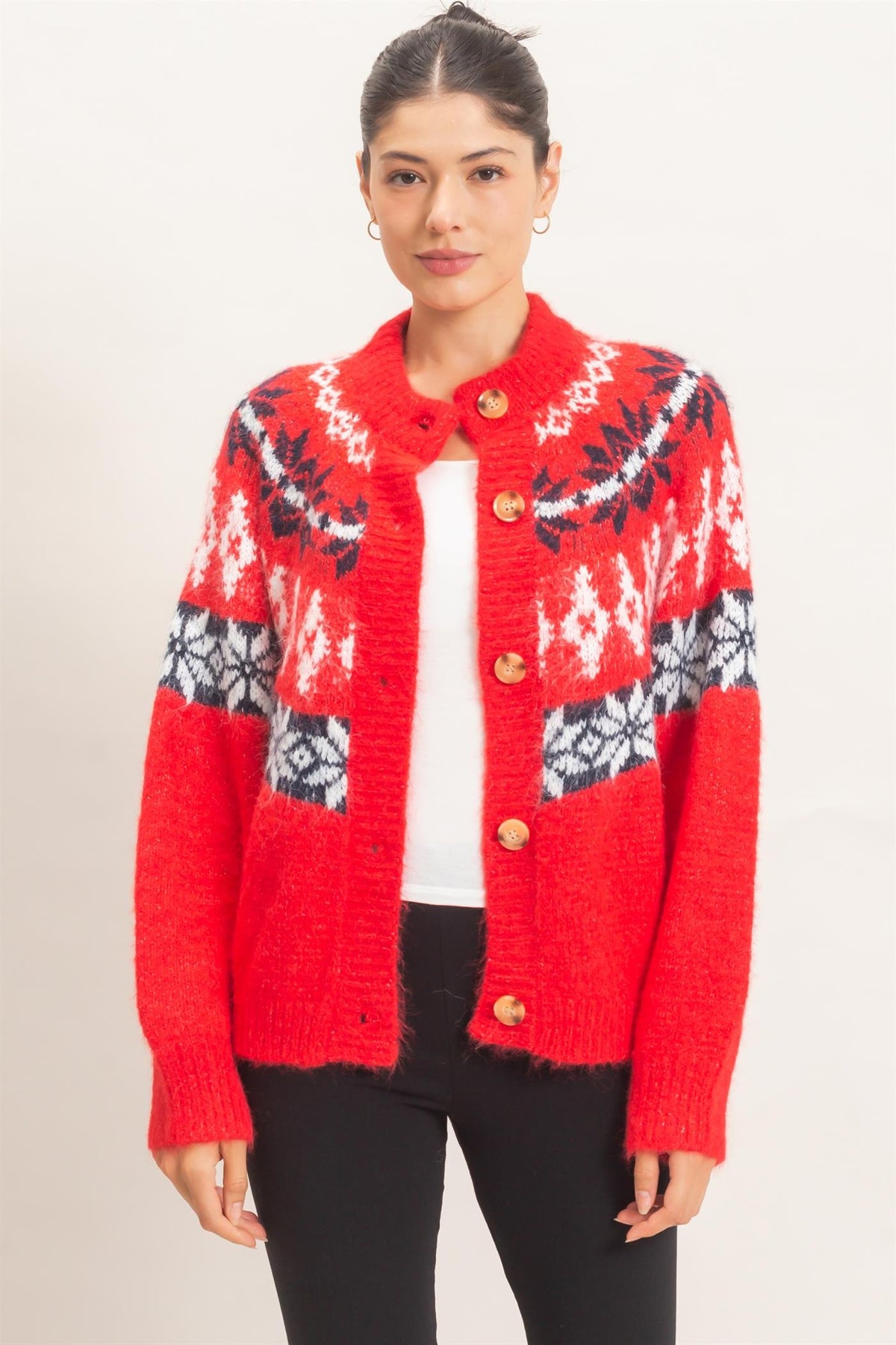 A cozy Fair Isle cardigan featuring classic snowflake motifs, a soft fuzzy texture, and a relaxed button-front silhouette perfect for chilly days.