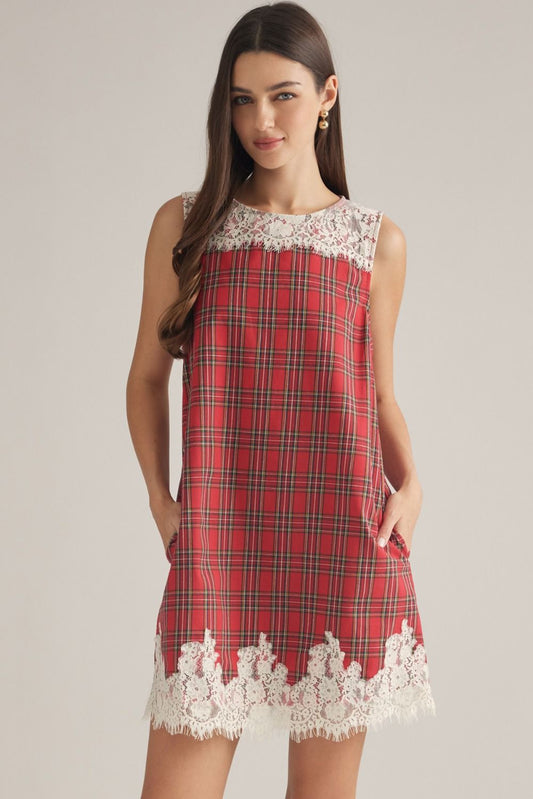 A charming plaid mini dress featuring a delicate lace yoke, lace-trimmed hem, and convenient side pockets for feminine everyday style.