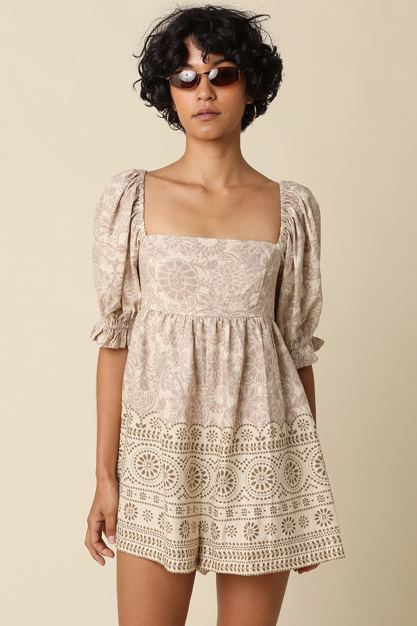 A breezy printed babydoll romper featuring a vintage-inspired print, square neckline, puff sleeves, and a flattering smocked back for effortless all-day style.
