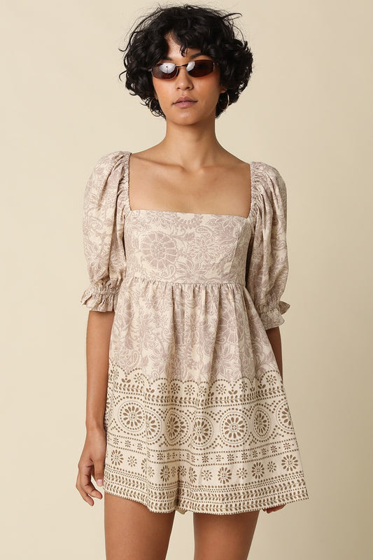 A breezy printed babydoll romper featuring a vintage-inspired print, square neckline, puff sleeves, and a flattering smocked back for effortless all-day style.
