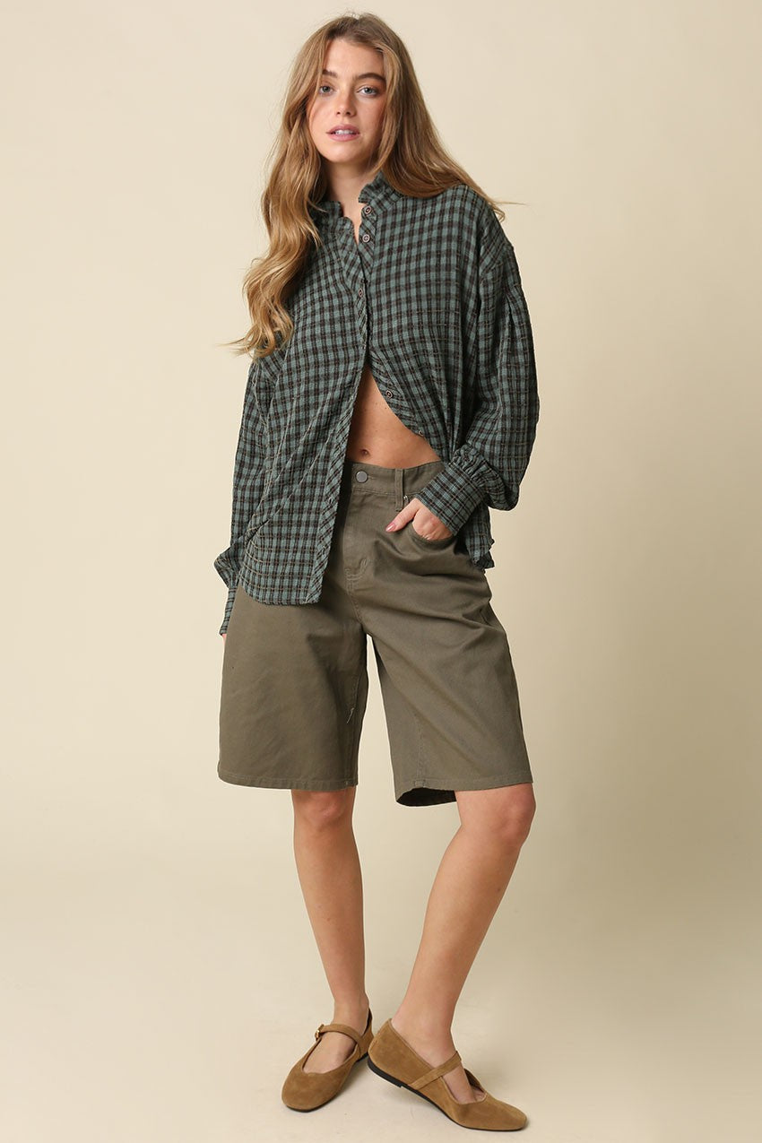 The Hayley Gingham Ruffle Blouse brings timeless charm to everyday style with a relaxed silhouette, romantic ruffle trim collar, and voluminous sleeves.