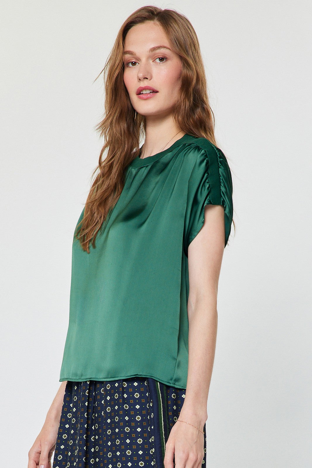 A chic satin-finish blouse featuring contrast neckline and shoulder details, gathered shoulders, and a relaxed boxy fit for effortlessly elevated everyday style.
