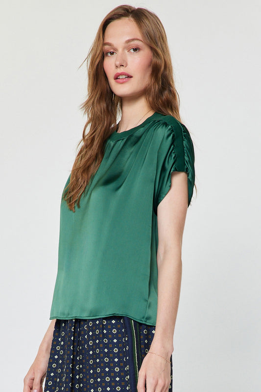 A chic satin-finish blouse featuring contrast neckline and shoulder details, gathered shoulders, and a relaxed boxy fit for effortlessly elevated everyday style.