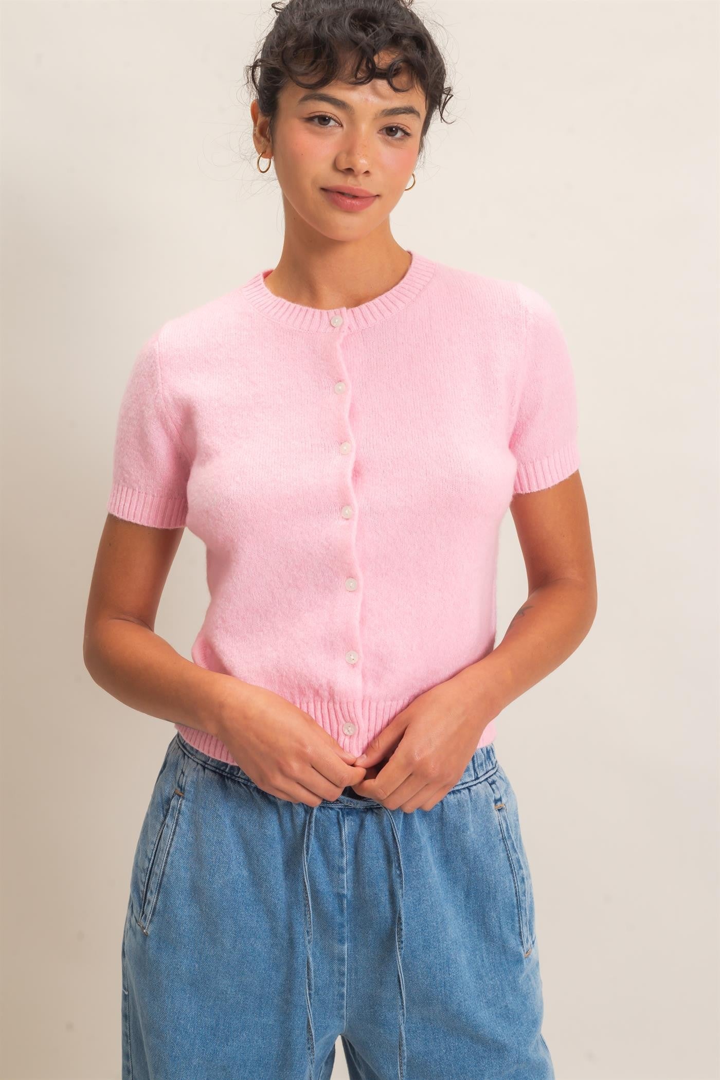 A polished, figure-flattering short-sleeve sweater with classic ribbed texture and button-front styling that makes effortless everyday dressing feel elevated.