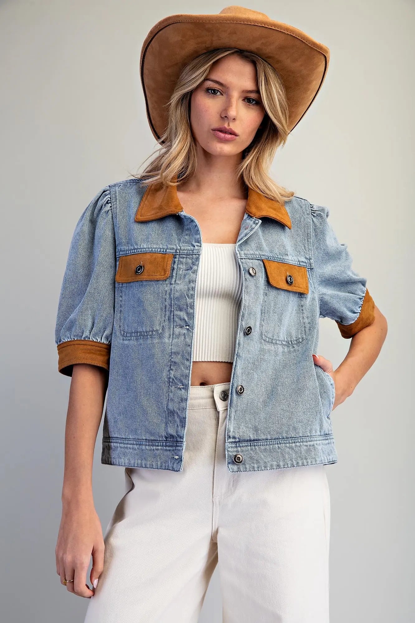 A fashion-forward mineral washed denim jacket accented with camel contrast trim, puff sleeves, and classic metal buttons for an elevated everyday layer.
