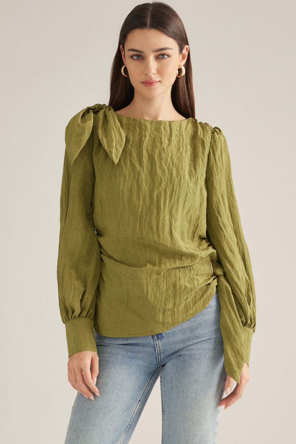 Elevate your wardrobe with this chic long-sleeve blouse featuring a straight neckline, feminine shoulder tie, and flattering side-wrap detail.

