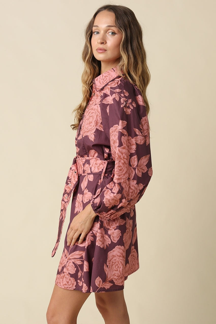 The Estelle Floral Belted Mini Dress combines a romantic floral print, voluminous puff sleeves, and a defined belted waist for effortlessly feminine style.