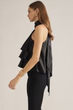 A feminine sleeveless top with layered ruffles, a high neckline, and a long self-tie scarf detail for an effortlessly polished look.